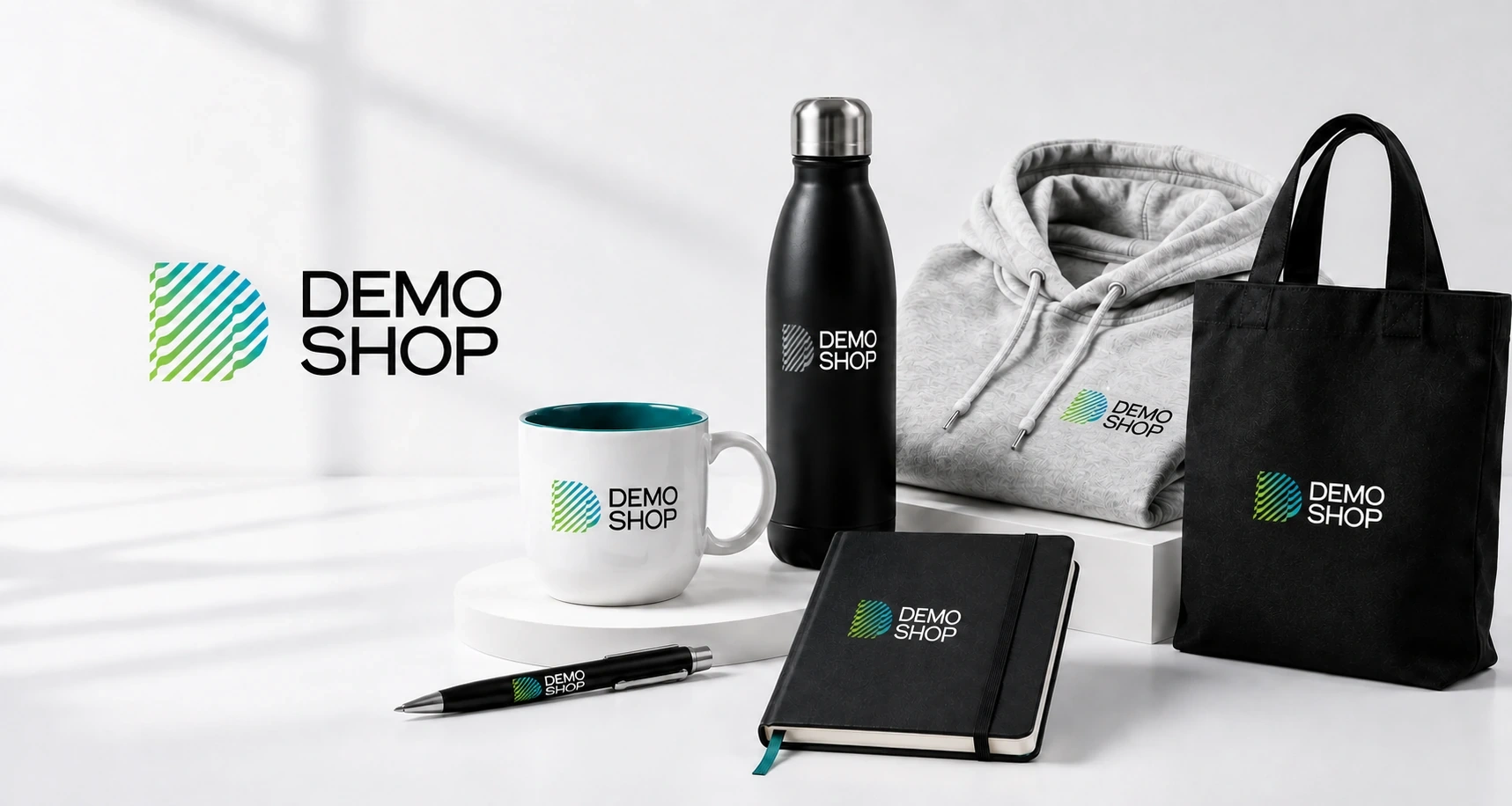 DemoShop promotivni proizvodi sa originalnim logotipom — šolja, boca, duks, ceger, notes i olovka